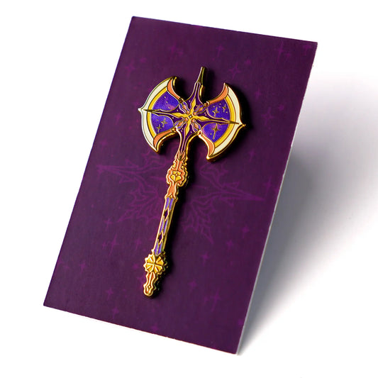 Celestial Armory Meteor Axe enamel pin by Naomi VanDoren featuring a detailed, space-inspired axe design on a black background.