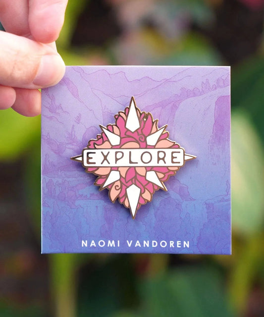 Explore enamel pin by Naomi VanDoren featuring a colorful adventure-themed design on a metal pin with a butterfly clasp.