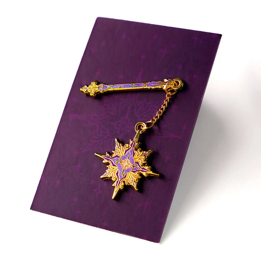 Celestial Armory Star Flail enamel pin by Naomi VanDoren featuring a star-shaped flail design on a black background.
