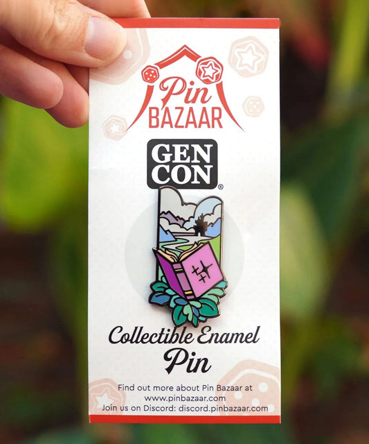 Floral enamel pin featuring a spell book design by Naomi VanDoren, part of the limited edition GenCon 2022 collection.