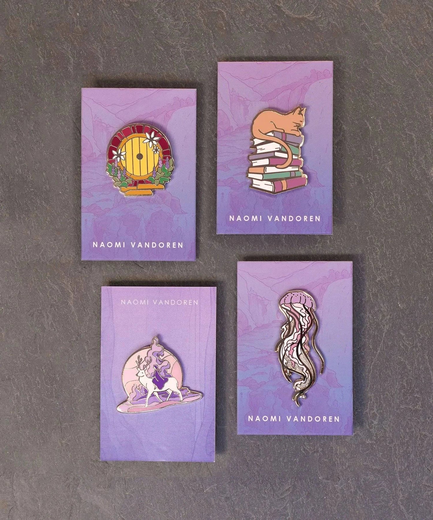 Enamel pin featuring a cat lounging on a stack of books by Naomi VanDoren, perfect for book and cat lovers.
