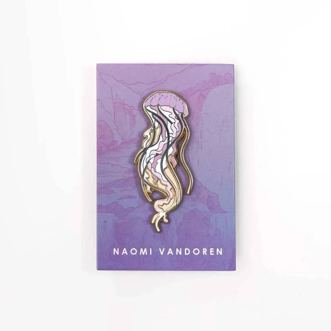 Sea jelly enamel pin by Naomi VanDoren featuring a colorful, detailed jellyfish design on a white background.