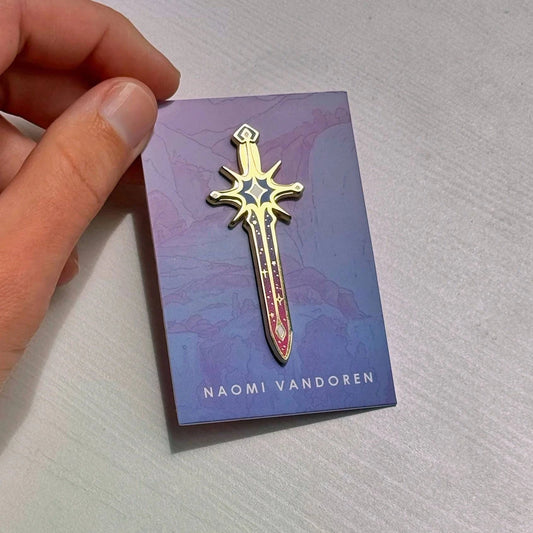 Star Sword enamel pin by Naomi VanDoren featuring a detailed star-shaped sword design on a metal pin backing.