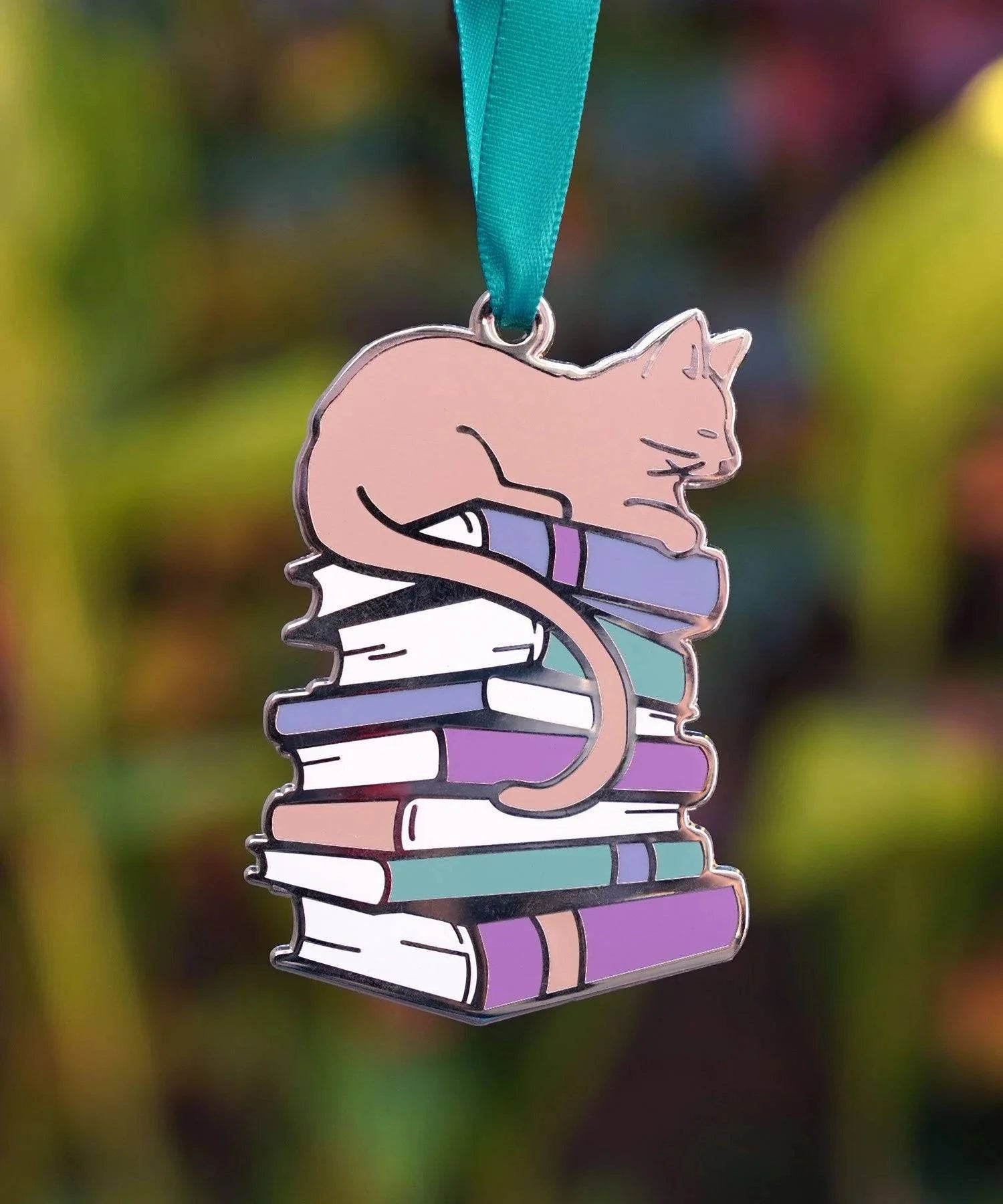 Cute ceramic cat ornament sitting on a stack of books, designed by Naomi VanDoren for Adventure Art & Stories.