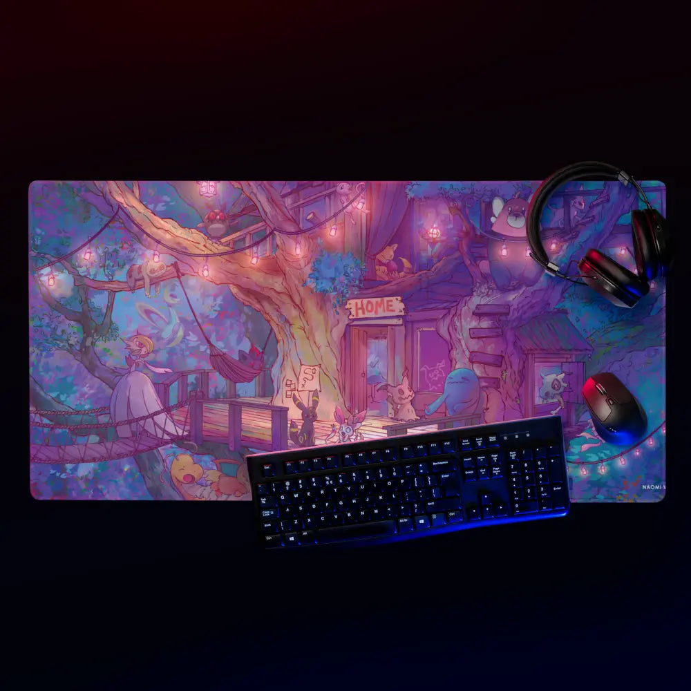 A large rectangular gaming desk mat with a colorful anime-style illustration, shown with a keyboard, mouse, and headphones on a dark background. The desk mat features a whimsical fantasy treehouse scene in purple, pink, and blue tones.