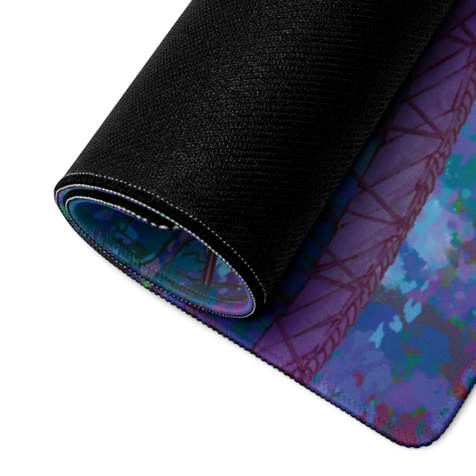 A close-up of a rolled black exercise or yoga mat showing its textured surface and a purple, blue, and teal abstract patterned underside.