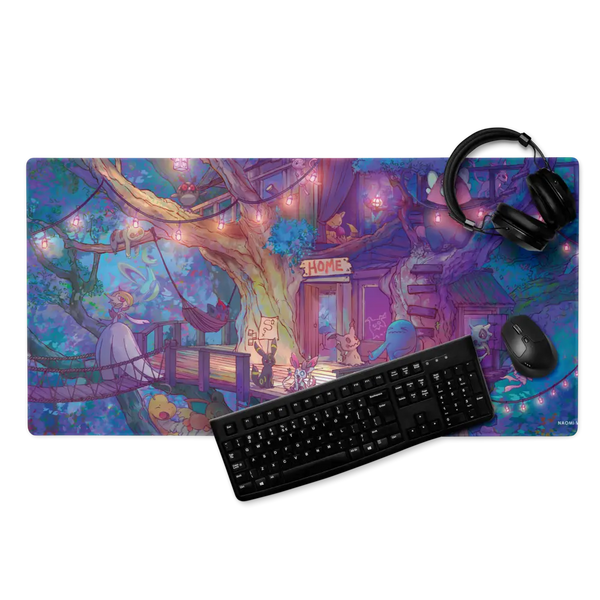 A large rectangular gaming desk mat with a colorful fantasy illustration, shown with a black keyboard, mouse, and over-ear headphones on a white background. The desk mat features a whimsical treehouse scene with purple, blue, pink, and yellow tones.