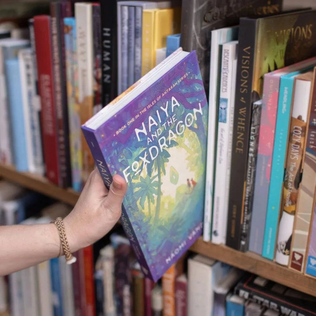 Illustrated novel Naiya and the Foxdragon by Naomi VanDoren on a bookshelf, featuring fantasy adventure art and story elements.